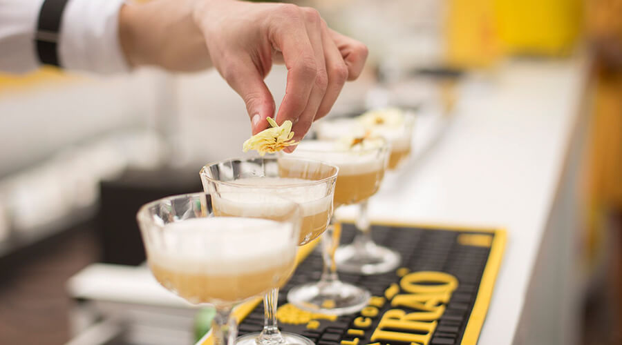 Line of cocktails on a bar.