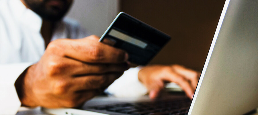 Man using a credit card to buy a product online.