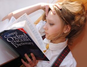 A girl reading the Oxford English Dictionary.